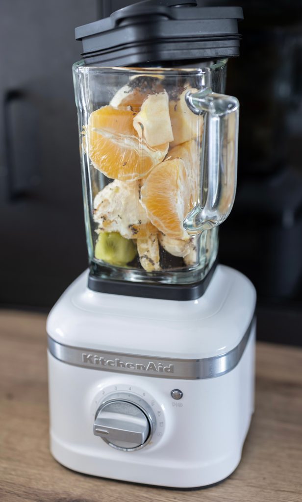 A blender with smoothie ingredients inside.
